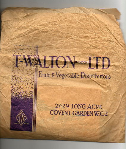 A creased brown paper bag with text reading: “T Walton (London) Ltd / Fruit & Vegetable Distributors / 27–29 Long Acre, Covent Garden W.C.2.”