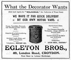 Advertisement headed “What the Decorator Wants”, listing items including “Paints, Varnishes, Enamels, and Brushes of best makers only”, “Horticultural Glass”, and “Large selection of British make [sic]” wallpaper.  A drawing of a paint can labelled “Bergers Paint” is in the centre.