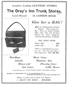 Advertisement headed “London’s Leading LEATHER STORES.  The Gray’s Inn Trunk Stores, Ltd., Local Branch — 44, London Road.”  It exhorts the reader to “Give her a BAG!” for Christmas, and lists other items sold: handbags; attaché, blouse, and suit cases; music cases; manicure sets; dressing cases; and collar boxes.  Branches are listed at 1b Euston Road NW1 and 1a Liverpool Street WC1, and the “Head Office & Warehouse” is listed at 7–9 Gray’s Inn Road WC1.