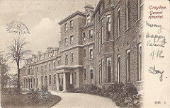 A postcard image of a three-storey building with a grand pillared entrance.  “Croydon.  General Hospital.” is printed in the top right corner, and under this “Many Happy Returns of the Day.” is handwritten in ink.