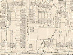 Map extract showing several interconnecting roads with terraced and semi-detached housing running along them.