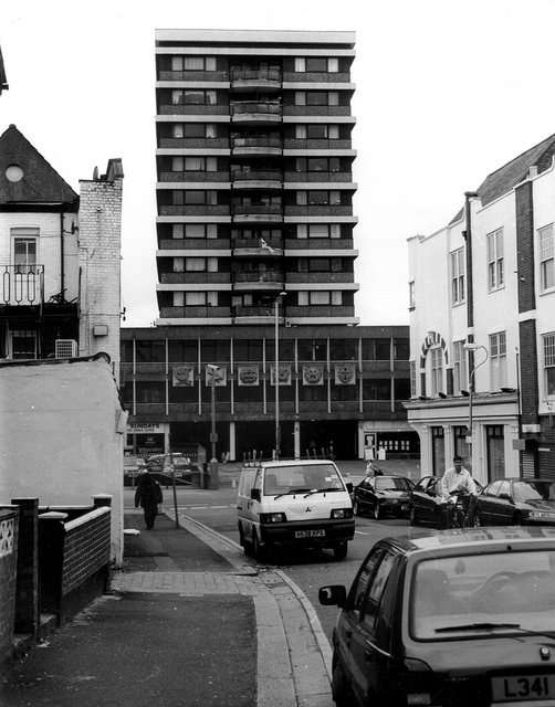 The same tower block as in the first picture, seen in the distance from some way down a side road.  This angle gives a clearer view of the six square zodiac-themed plaques on the frontage.