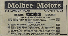A newspaper advert headed “Molbee Motors”, listing several cars for sale including a new Ford Anglia at £538 and used cars ranging in price from £259 for a 1957 Ford Prefect to £725 for a 1962 Vauxhall VX.