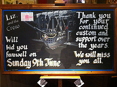 A sign written on a blackboard, reading: “Liz and the crew will bid you farewell on Sunday 9th June. Thank you for your continued custom and support over the years. We will miss you all.” There's also a drawing of a ship emerging from a tall three-storey terraced building resembling the one the pub currently resides in.