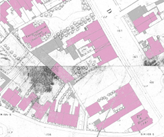 A large-scale map showing buildings on either side of a road. Some of the buildings are coloured in pink or grey.