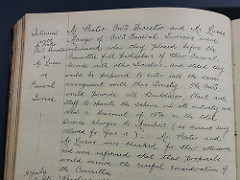 Excerpt from handwritten minutes of a committee meeting, in dark ink on a left-hand page of a minute book with ruled lines and margin.  An indexing note in the margin reads: “Interview with Mr. Prater CWS Director & Mr. Lucas re Funeral Service”.