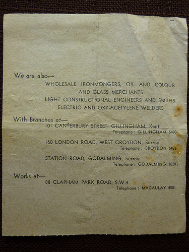 The back of the receipt shown in the previous image, with printed text stating that “We are also— wholesale ironmongers, oil and colour and glass merchants / light constructional engineers and smiths / electric and oxy-acetylene welders”.  Branch addresses are given at 101 Canterbury Street, Gillingham, Kent; 160 London Road, West Croydon; and Station Road, Godalming, Surrey.  The works address is 88 Clapham Park Road, SW4.