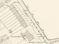 A black-and-white map showing houses along the side of a road.  A tramway is marked along the road, which runs from southeast to northwest.