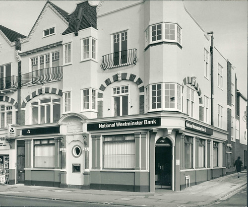 Another view similar to the previous one, but now the “National Westminster Bank” sign extends to the next-door property as well, and the recessed doorway between the two has been blocked up aside from a circular porthole.