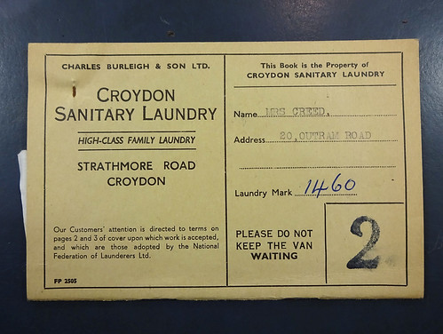 A small beige booklet printed with the name “Charles Burleigh & Son / Croydon Sanitary Laundry”.  A customer’s name — “Mrs Creed” of “20 Outram Road” — is typewritten in capitals, and a “Laundry Mark” of “1460” is handwritten in pen.  Below is an admonition: “Please do not keep the van waiting”.