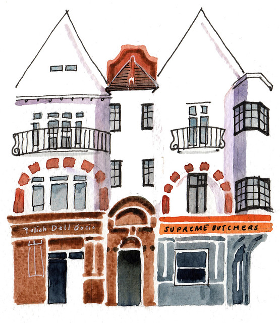 An ink and watercolour sketch showing part of a three-storey terrace with shops on the ground floor and windows with balconettes on the upper floors.  On the right is “Supreme Butchers” in orange and dark grey, and on the left is “Polish Deli Gucio” in brown.